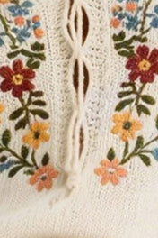 Close-up of a textured fabric with floral embroidery