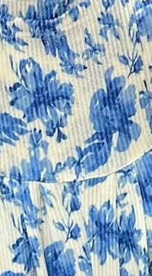 Close-up of blue floral pattern on a textured fabric background