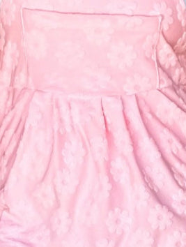 Close-up of a pink textured fabric with a pocket.