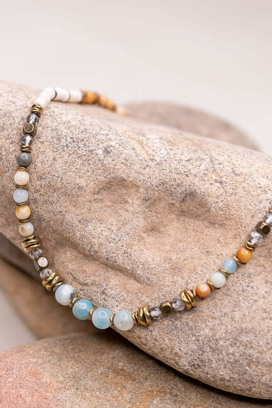 Beaded necklace on a stone surface