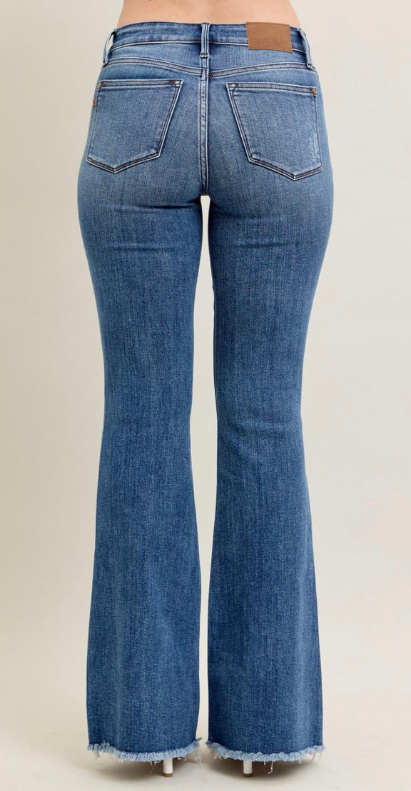 Blue flared jeans on a beige background