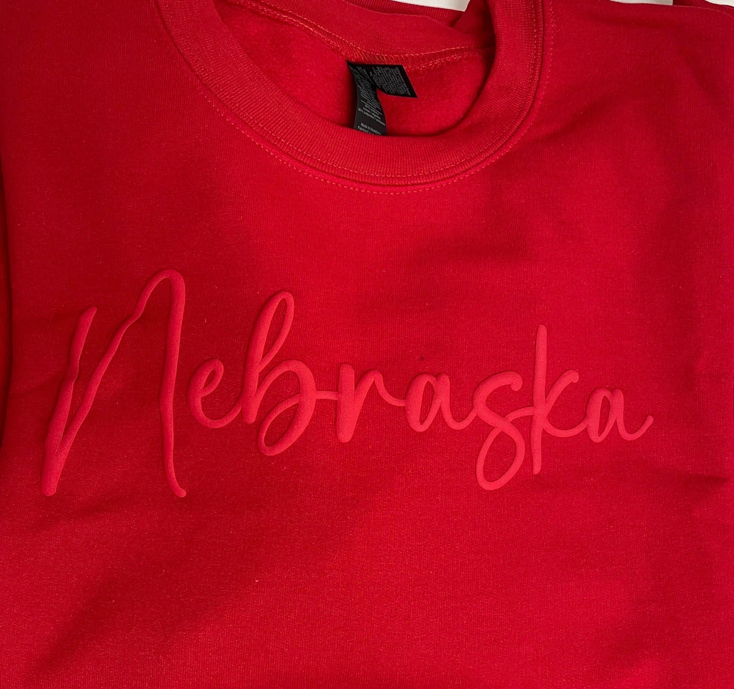 Red sweatshirt with 'Nebraska' printed on it