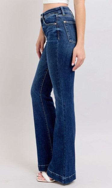 Blue jeans worn by a person on a plain background