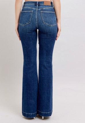 Blue jeans being worn on a plain background