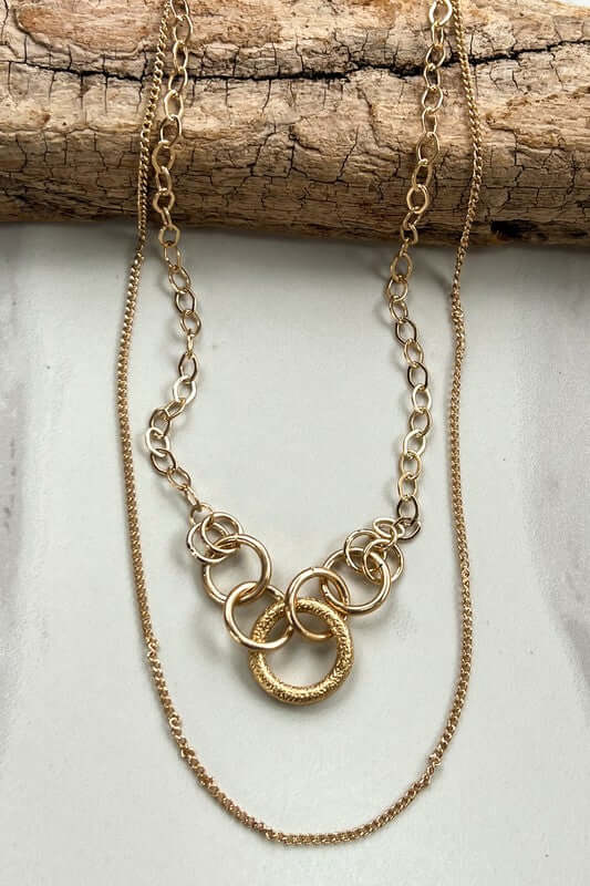 Short, 2 layer chain link necklace. Each chain in unique and one has connected hoops. Includes a lobster claw closure