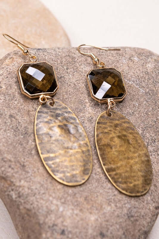 Fishhook earrings with textured metal oval and smokey crystal charm