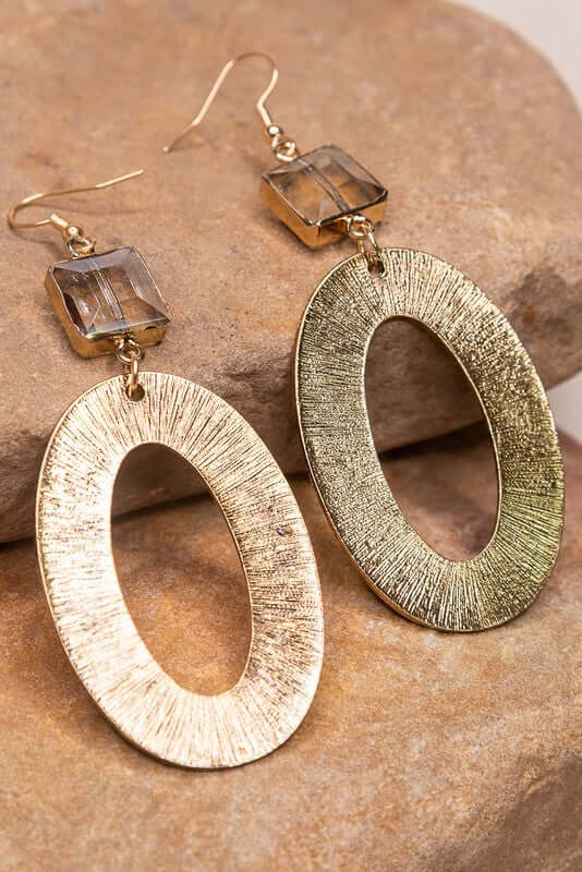 Fishhook earrings with textured metal oval hoop and crystal charm. 3" off the drop with fishhook earring closure. Crystal Charm: .5" Oval Hoop: 2"