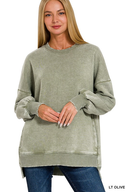 Woman wearing a light olive green sweater on a white background