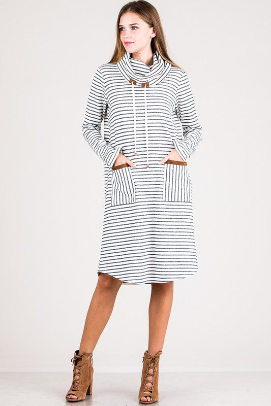 Woman wearing a black and white striped dress with a hood on a white background