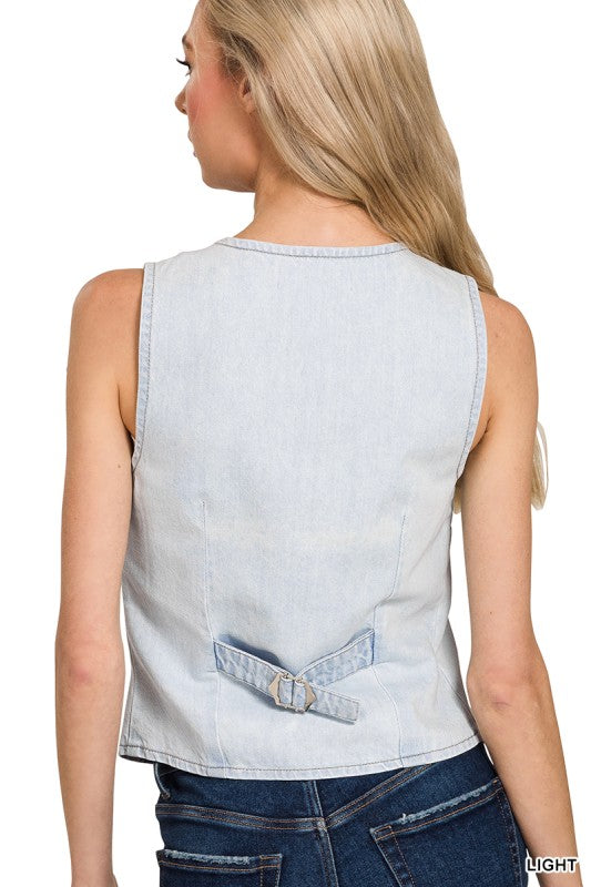 Light blue denim sleeveless top worn by a person on a white background