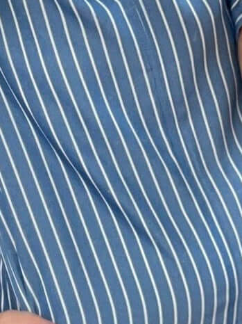 Close-up of blue fabric with white vertical stripes