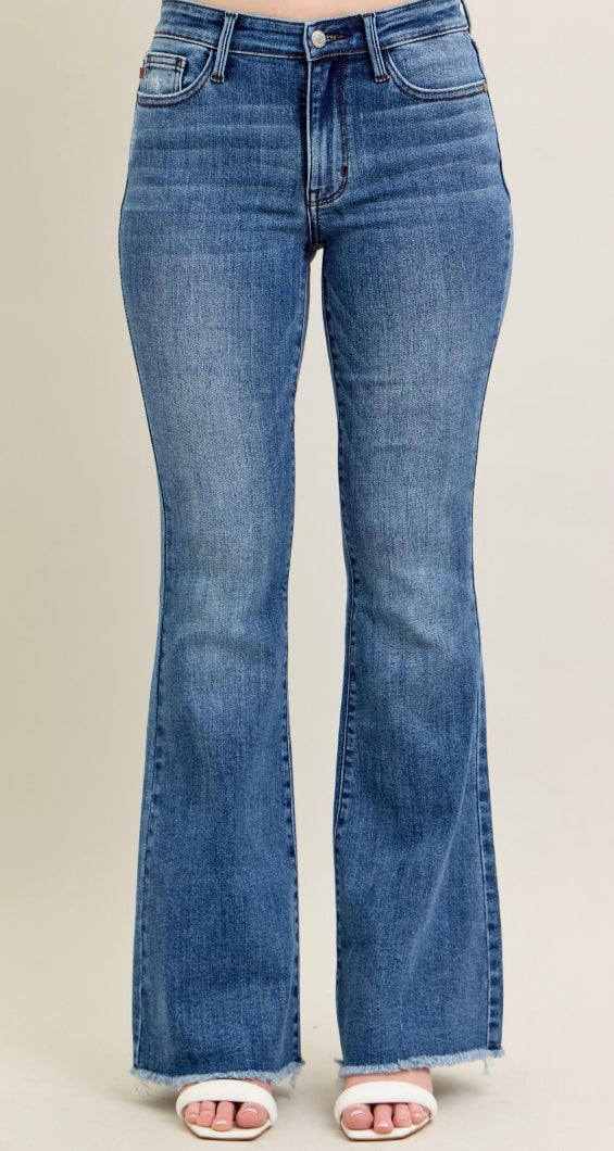 Blue flared jeans on a plain background