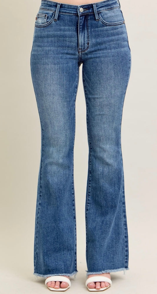Blue flared jeans on a plain background