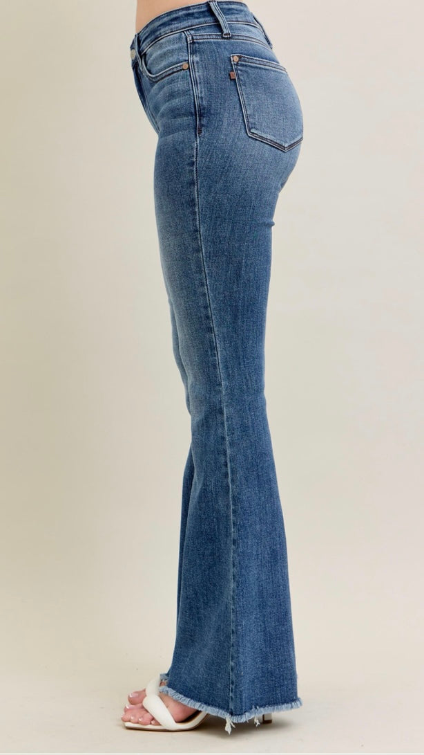 Blue flared jeans on a plain background