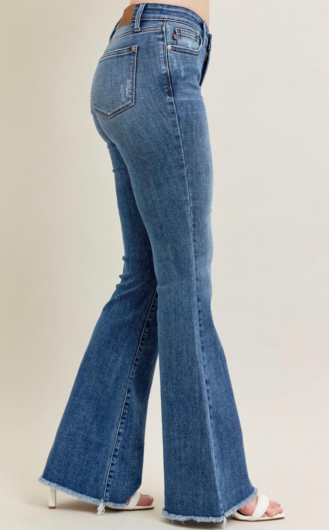 Blue flared jeans on a beige background