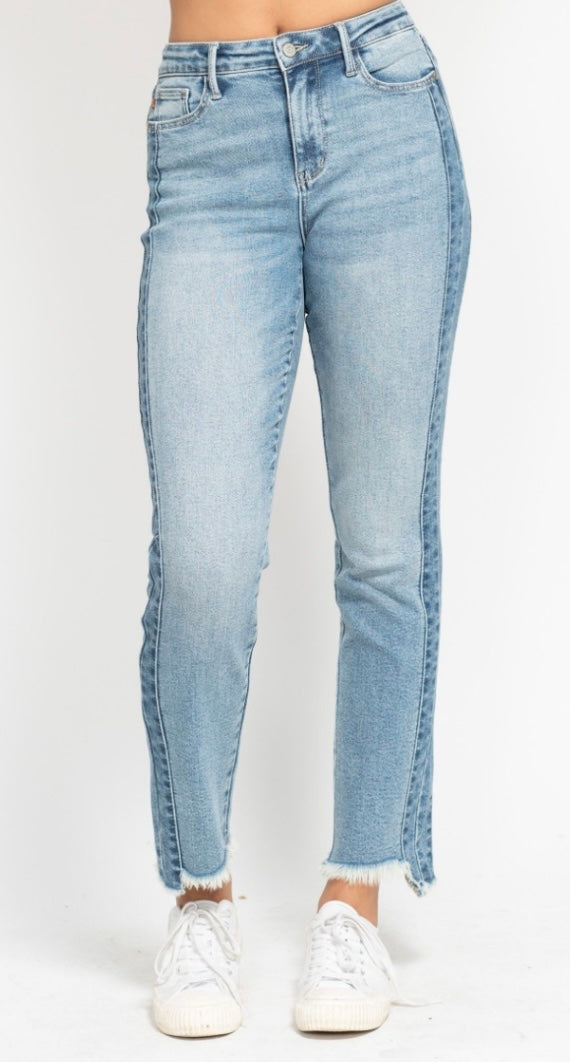 Light blue jeans worn by a person on a white background