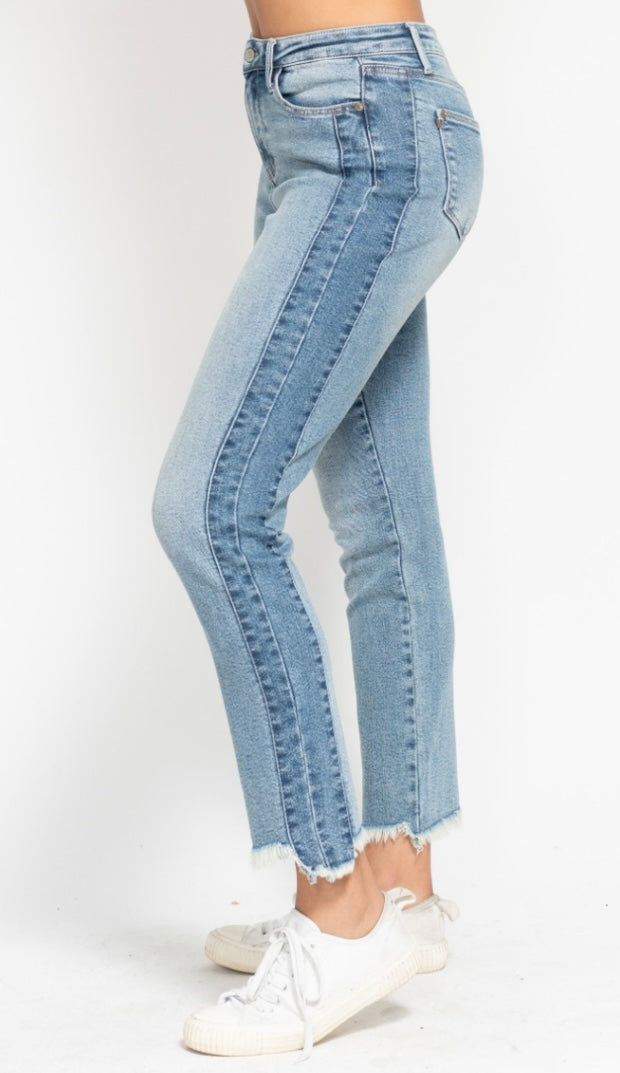 Light blue jeans worn by a person on a white background
