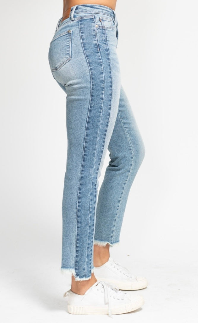 Light blue jeans worn by a person on a white background